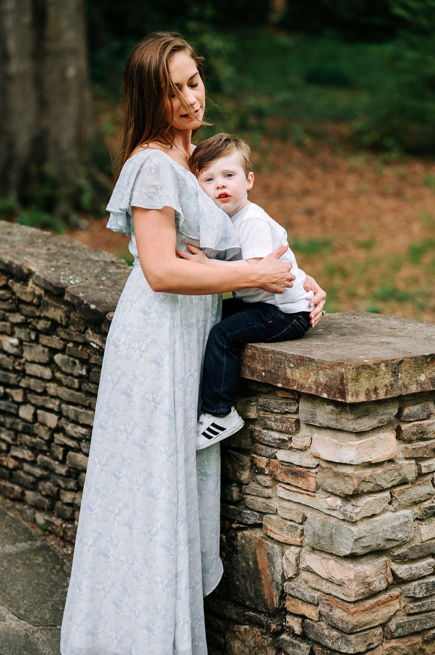 mother and son on stone wall