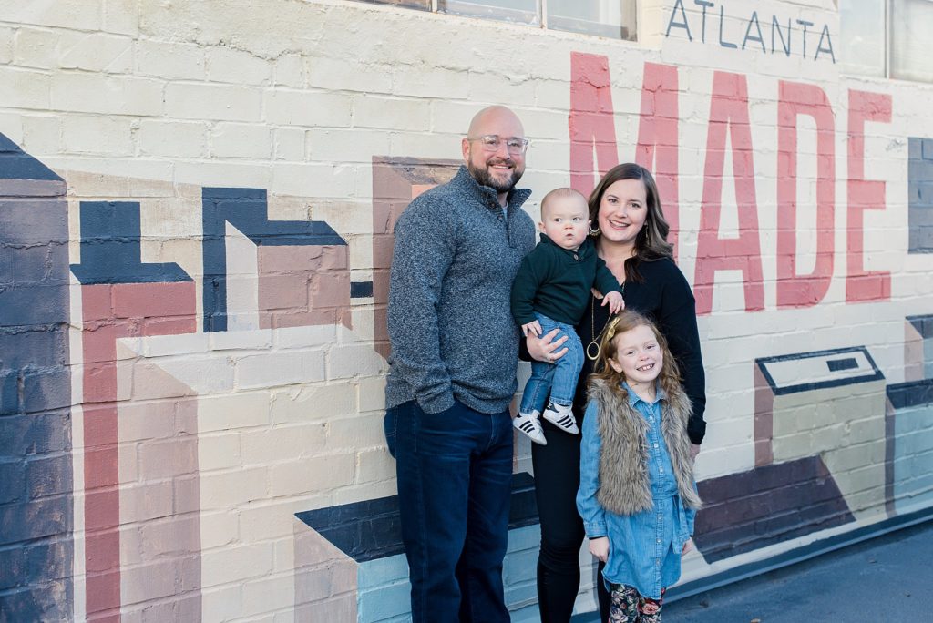 family in fall in front of made in Atlanta sign