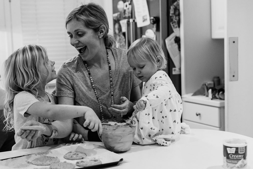 mother and daughters baking cookies