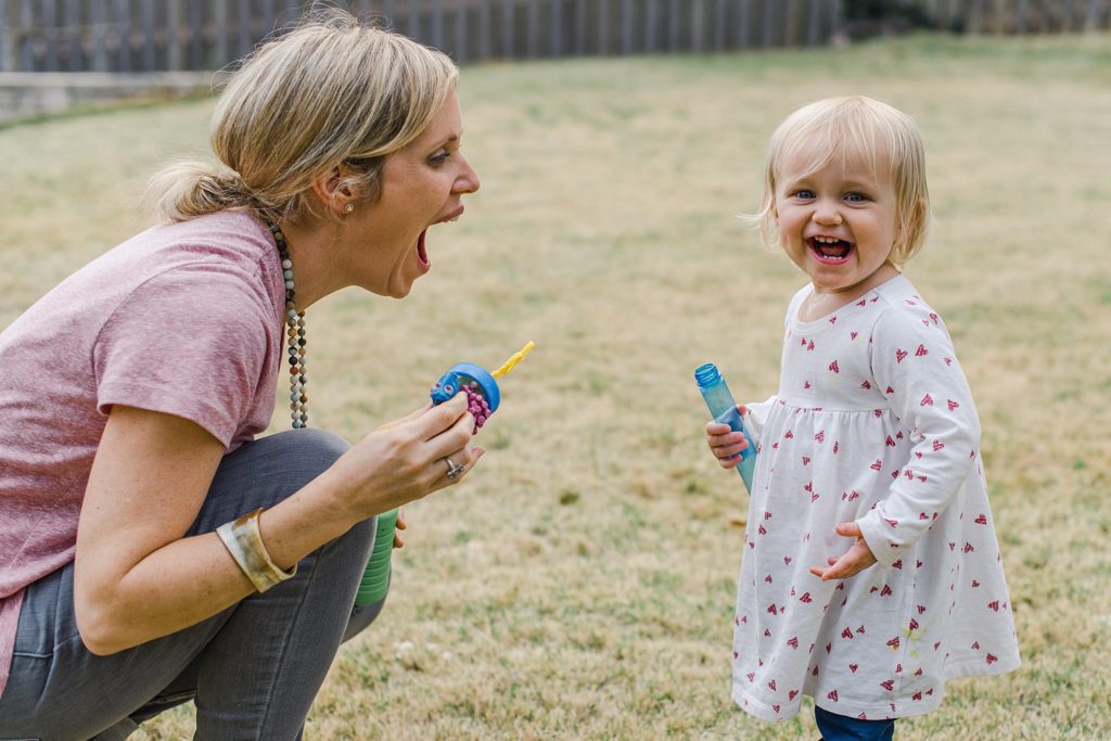 mother and daughter blowing bubbles