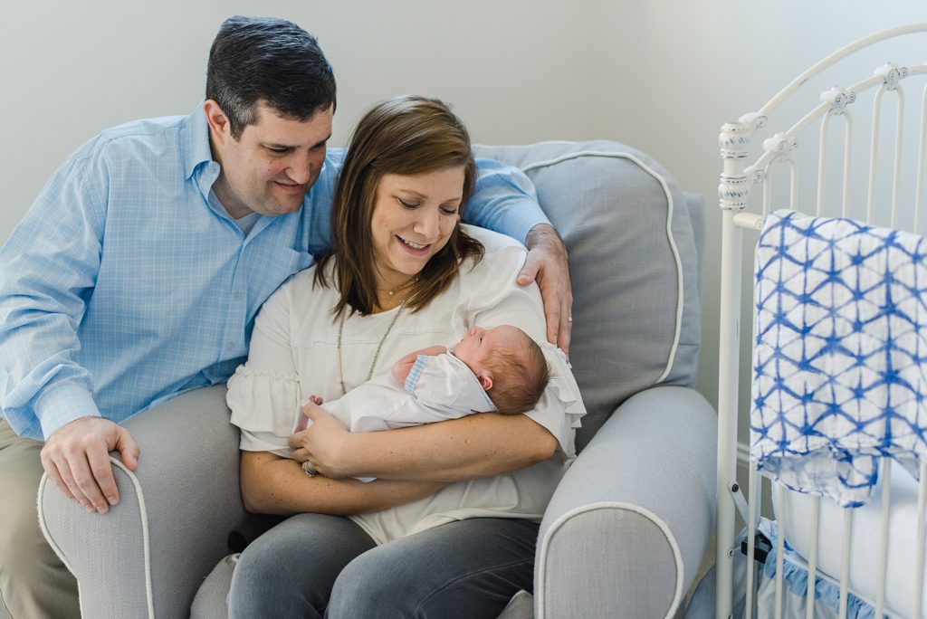 newborn baby boy and parents in chair