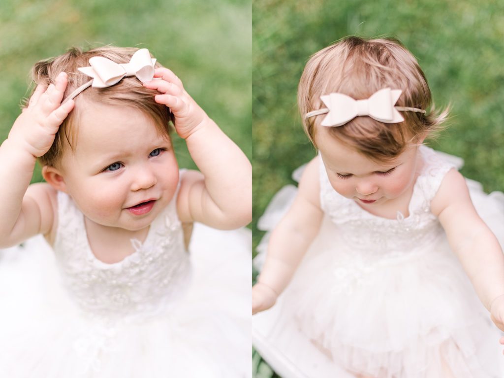 one year old girl in white dress and white bow