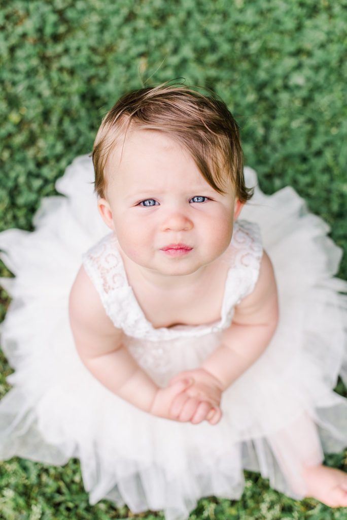 one year old girl in white dress