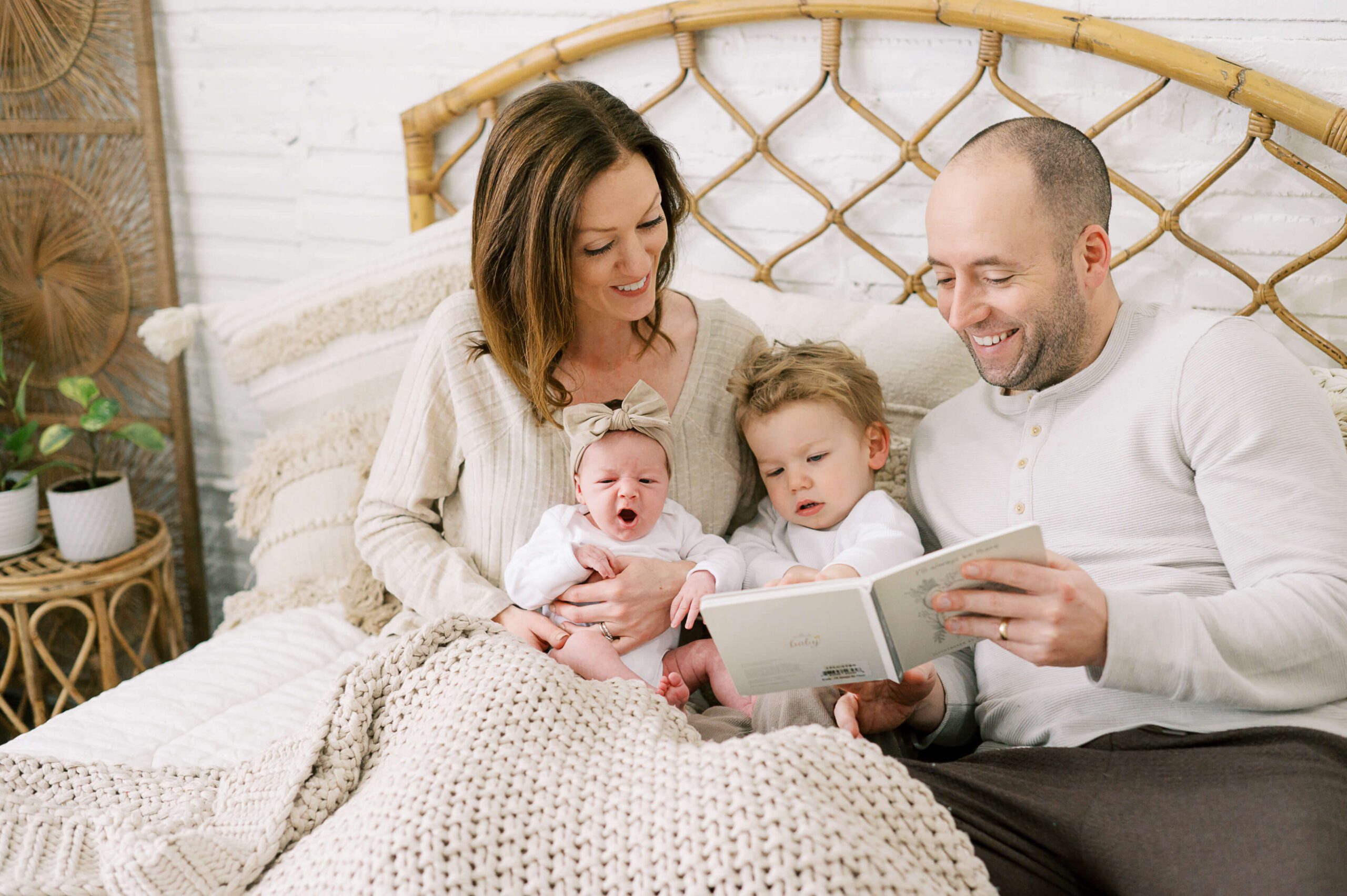 family reading story in bed